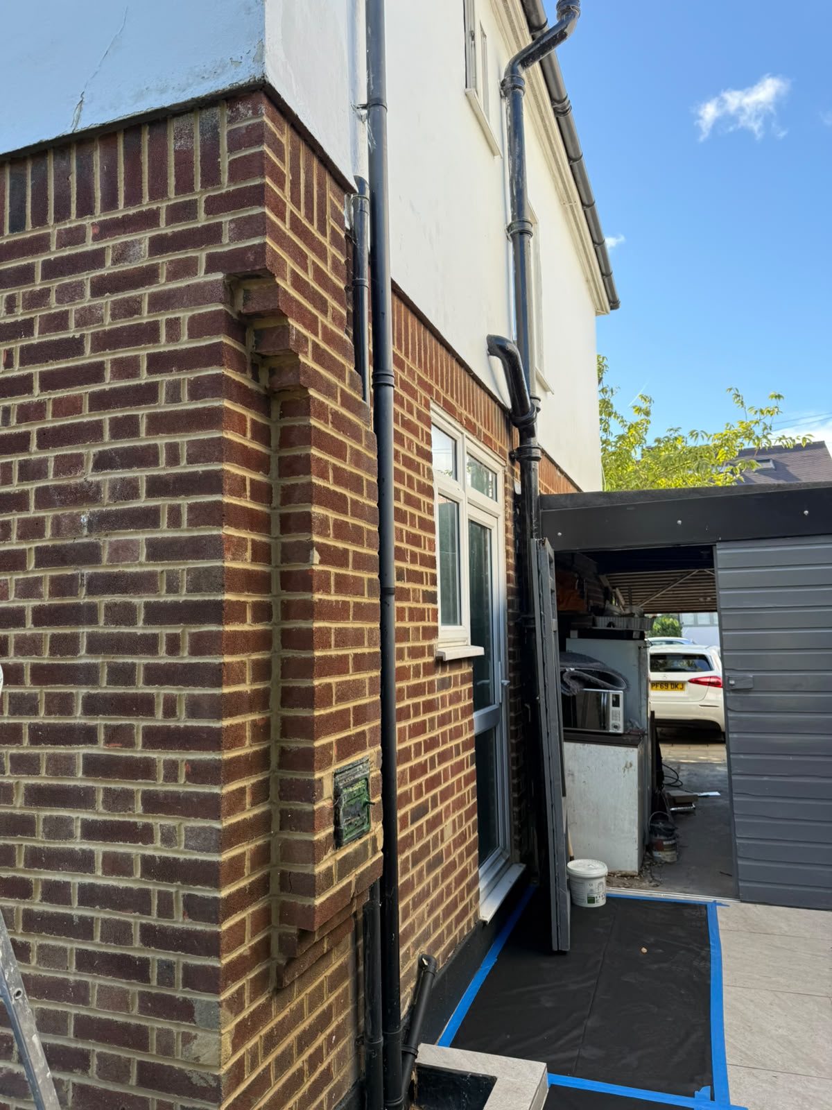 Exterior brickwork prepared and sheeted for rendering and painting