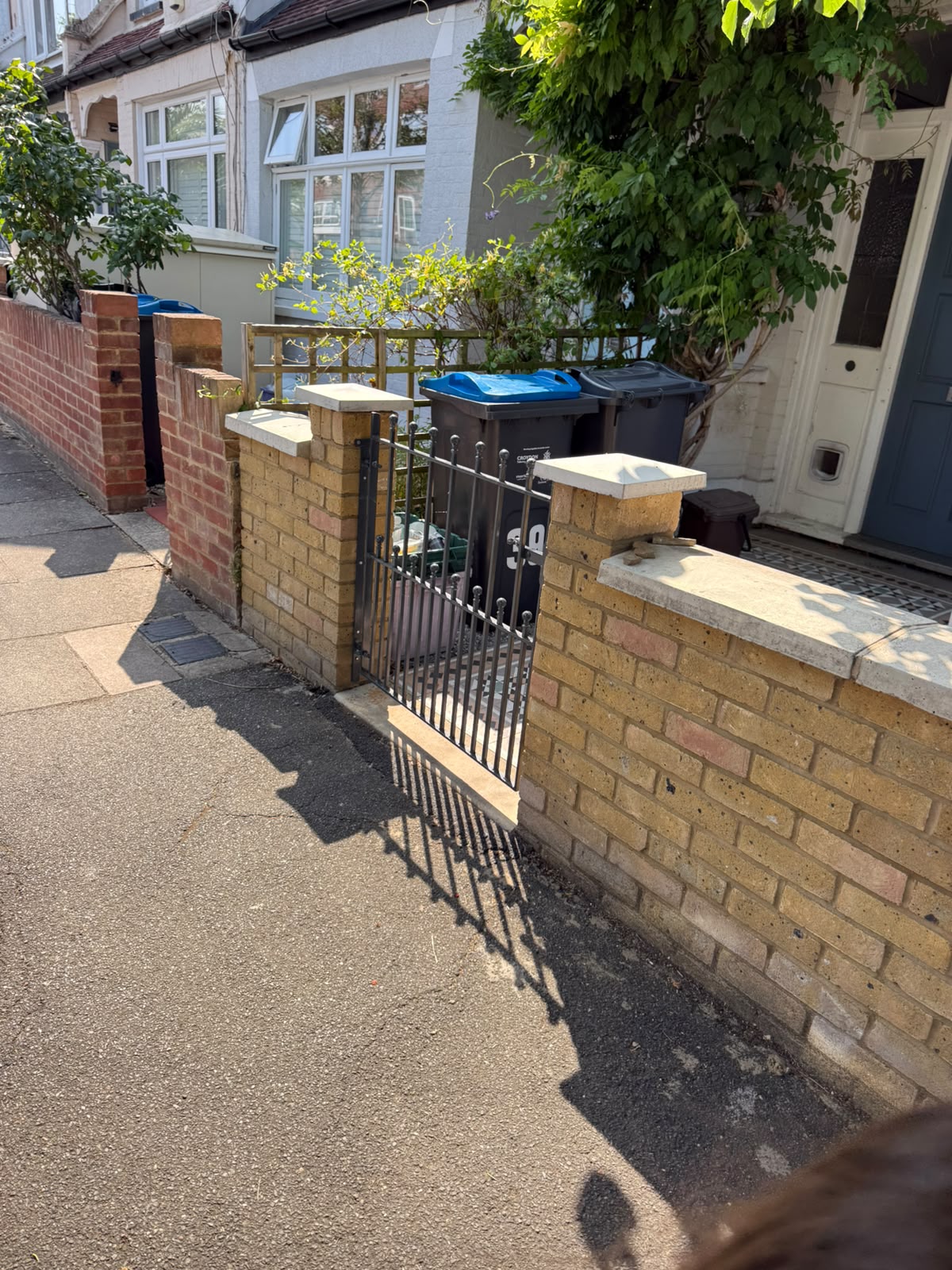 Rebuilt front garden wall with new metal gate