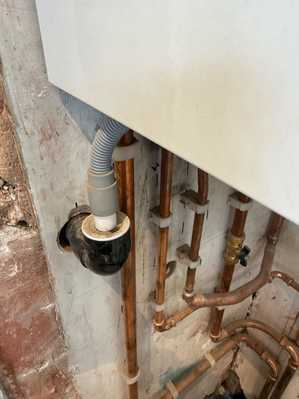 New copper pipework installed under a bathroom basin