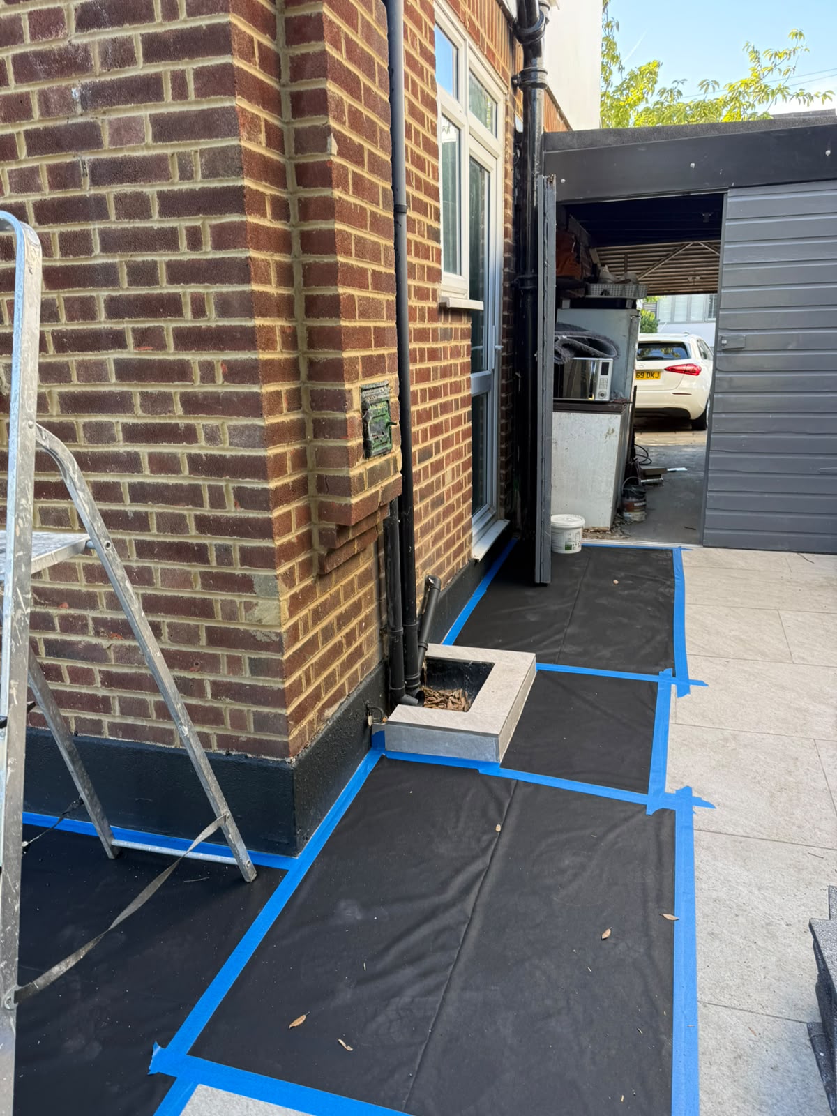 External walls sheeted and masked ready for painting